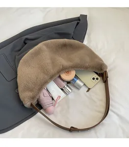 Detailed view of the large capacity plush dumpling bag showing phone and umbrella storage