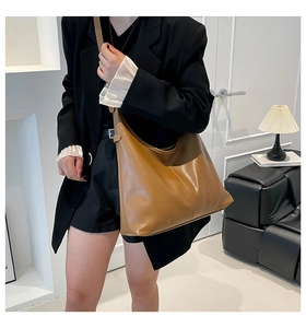Close-up of a brown retro hobo shoulder bag styled in a minimalist interior setting