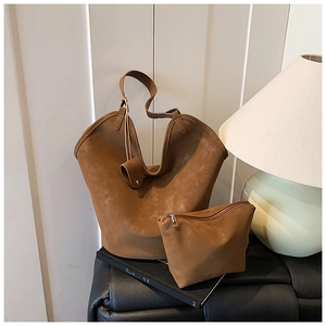 Detailed view of vintage brown matte hobo bag and matching pouch set in lifestyle setting