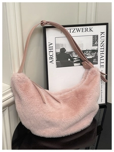 Detail view of the pink faux fur crescent bag showing high-quality adjustable leather strap
