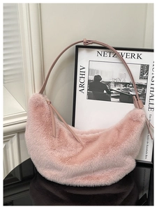 Detail of plush pink crescent bag showing soft faux fur texture and leather strap