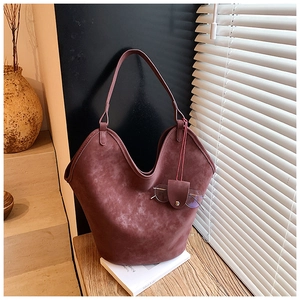 Deep red frosted leather tote bag with unique wavy top edge and eyeglass holder detail