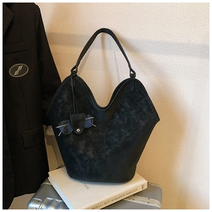 Detail of matte black tote bag featuring a practical glasses holder and large capacity