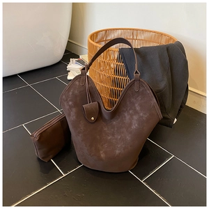 Detail of vintage brown suede tote bag with V-shaped opening and inner pouch set