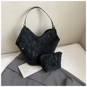Close-up of black marble texture tote bag with wave edge and matching zip pouch
