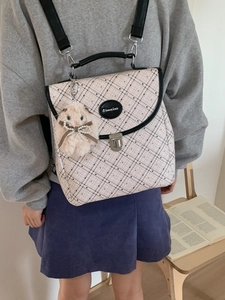 Minimalist cream plaid backpack for women featuring a metal buckle and plush bunny charm