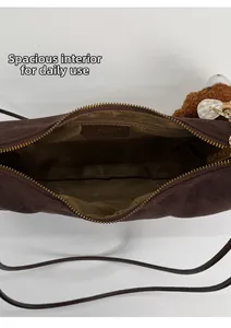 Detail view of large interior capacity and zippered pocket in leopard print bag