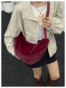 Deep red faux fur crescent bag shown with a leather strap for autumn winter fashion style