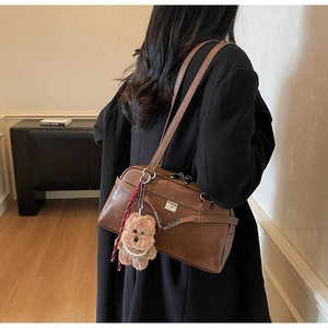 Brown retro Boston shoulder bag with silver hardware and a cute plush bear charm detail