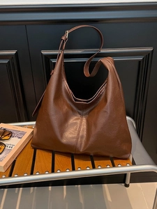 Vintage dark brown faux leather hobo bag with adjustable strap and minimalist stitching