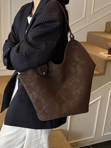Vintage dark brown large suede tote bag for women worn with a striped blazer outfit