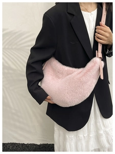 Pink faux fur hobo bag shown with black blazer and white skirt outfit details