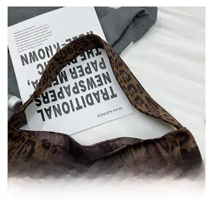 Detail view of the leopard print tote bag interior with smooth brown satin lining