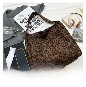 Top view of a large leopard print tote bag with soft suede texture and wide shoulder strap