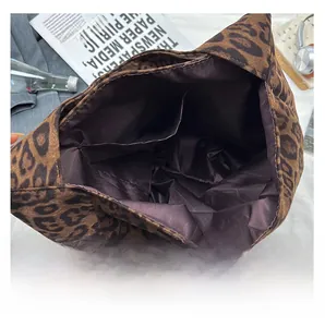 Internal structure of leopard tote bag showing two open pockets and brown fabric lining