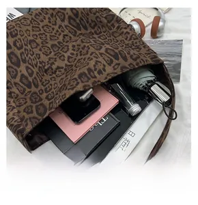 Detail showing high-capacity interior of leopard print tote bag with daily essentials