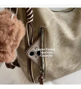 Detail of olive green canvas bag side zipper pocket showing large capacity for mobile phones