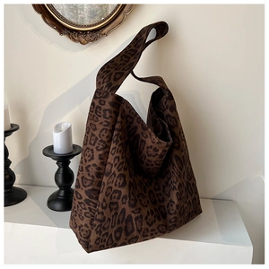 Close-up of leopard print hobo tote bag in a vintage indoor setting with a round mirror