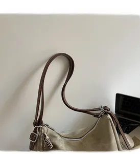 Detail of olive canvas tote bag with brown leather handles and silver metal hardware