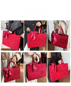 Détail du cabas en jacquard rouge avec motifs floraux et nœud en soie imprimé