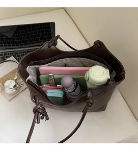 Top view of large capacity dark brown tote bag showing internal storage for laptop and items