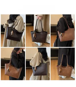 Detail view of large tote bag with bohemian bead charm in dark and light brown colors