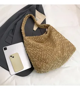 Detailed view of a brown plush tote bag showing large capacity for laptop and daily items