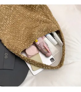 Spacious interior of khaki plush tote bag showing items like umbrella and phone