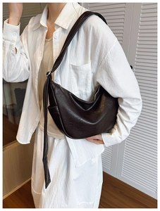 Deep coffee brown hobo bag with wide shoulder strap and side pocket detail