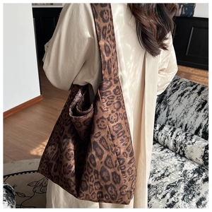 Close-up of a large leopard print tote bag with soft fabric texture for commuting
