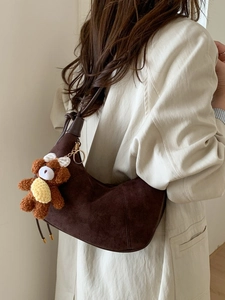Deep brown faux suede hobo bag with plush bear charm and vintage stitch details