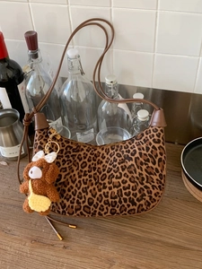 Vintage leopard print suede crescent shoulder bag with tassel and plush bear charm