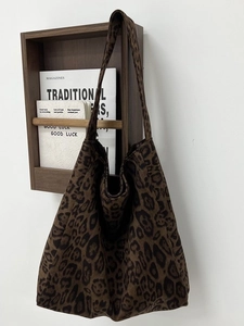 Retro leopard print tote bag with large capacity and wide shoulder strap hanging on wall