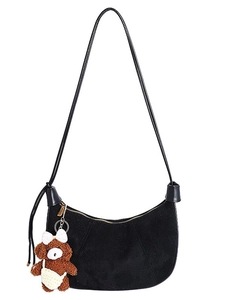 Minimalist black suede crescent shoulder bag with a cute plush brown bear keychain