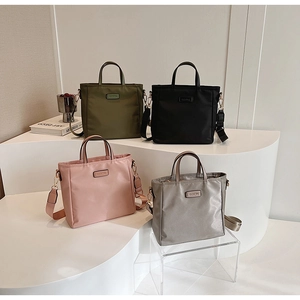 Detailed view of nylon tote bags in four colors with detachable shoulder straps
