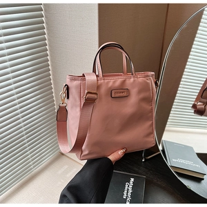 Pink nylon tote bag detail with CLEAROK logo and adjustable wide shoulder strap