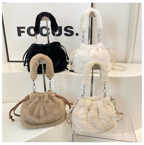 Detail view of plush bucket bags in four colors with drawstring and chain straps