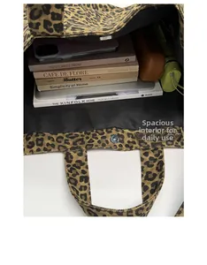 Spacious interior of leopard print canvas tote bag showing books and daily essentials
