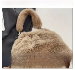 Detailed view of soft khaki plush fabric and silver metal handle ring on the handbag