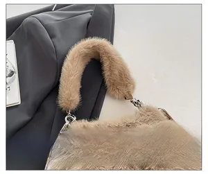 Detailed close-up of brown plush faux fur handbag with silver metal ring and leather trim