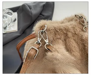 Detail of silver metal buckle and brown plush faux fur texture on the chain bag