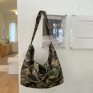 Detailed macro of the durable camouflage canvas tote bag with a wide shoulder strap