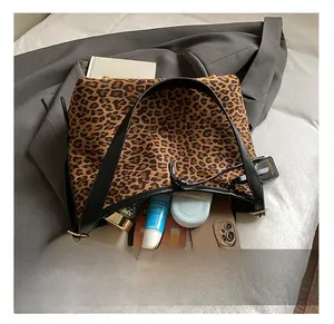 Detail showing spacious leopard print tote interior holding tablet and daily essentials