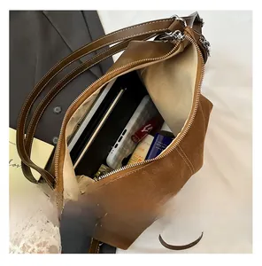 Internal view of a spacious brown suede tote bag showing large storage capacity