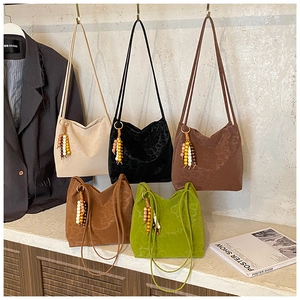 Detailed view of plush leopard print bucket bags in five stylish colors with beaded charms