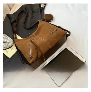 Brown frosted leather tote detail with circular coin purse and metal zipper ornament