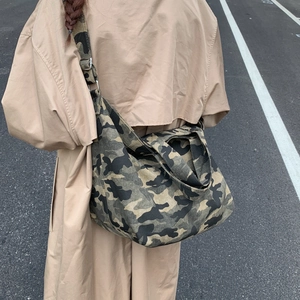 Outdoor model showing large capacity camouflage canvas tote bag with adjustable strap