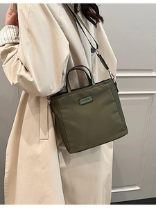 Waterproof olive green nylon crossbody bucket bag with adjustable wide strap and top handles