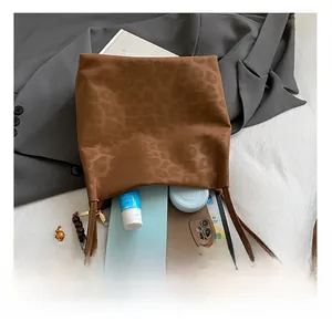 Detailed view of spacious leopard print bucket bag interior with daily essentials
