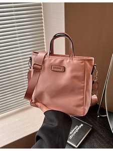 Chic pink nylon bucket bag with wide strap and gold metal buckles for women
